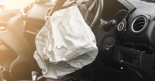 A car's airbag deployed after an electronic bicycle accident.