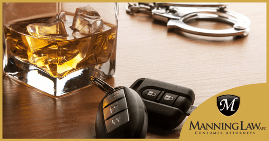 glass of alcohol next to car keys and handcuffs