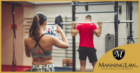 woman using tablet to record video at the gym