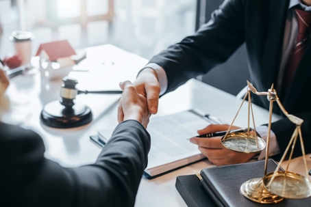 Lawyer shaking hands with client