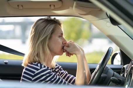 woman anxious behind the wheel of car